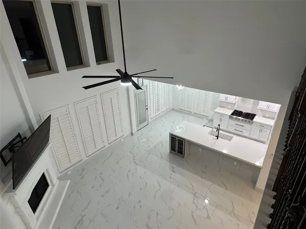 a view of a hallway with wooden floor and a cabinet