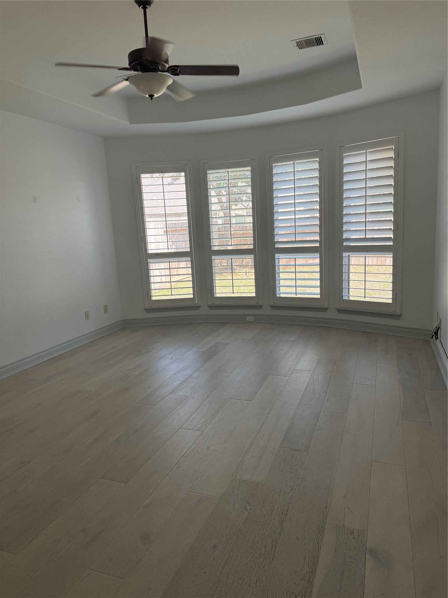 5003 Raudabaugh Drive Katy, TX 77494 - Photo 31 of 36 an empty room with wooden floor and windows
