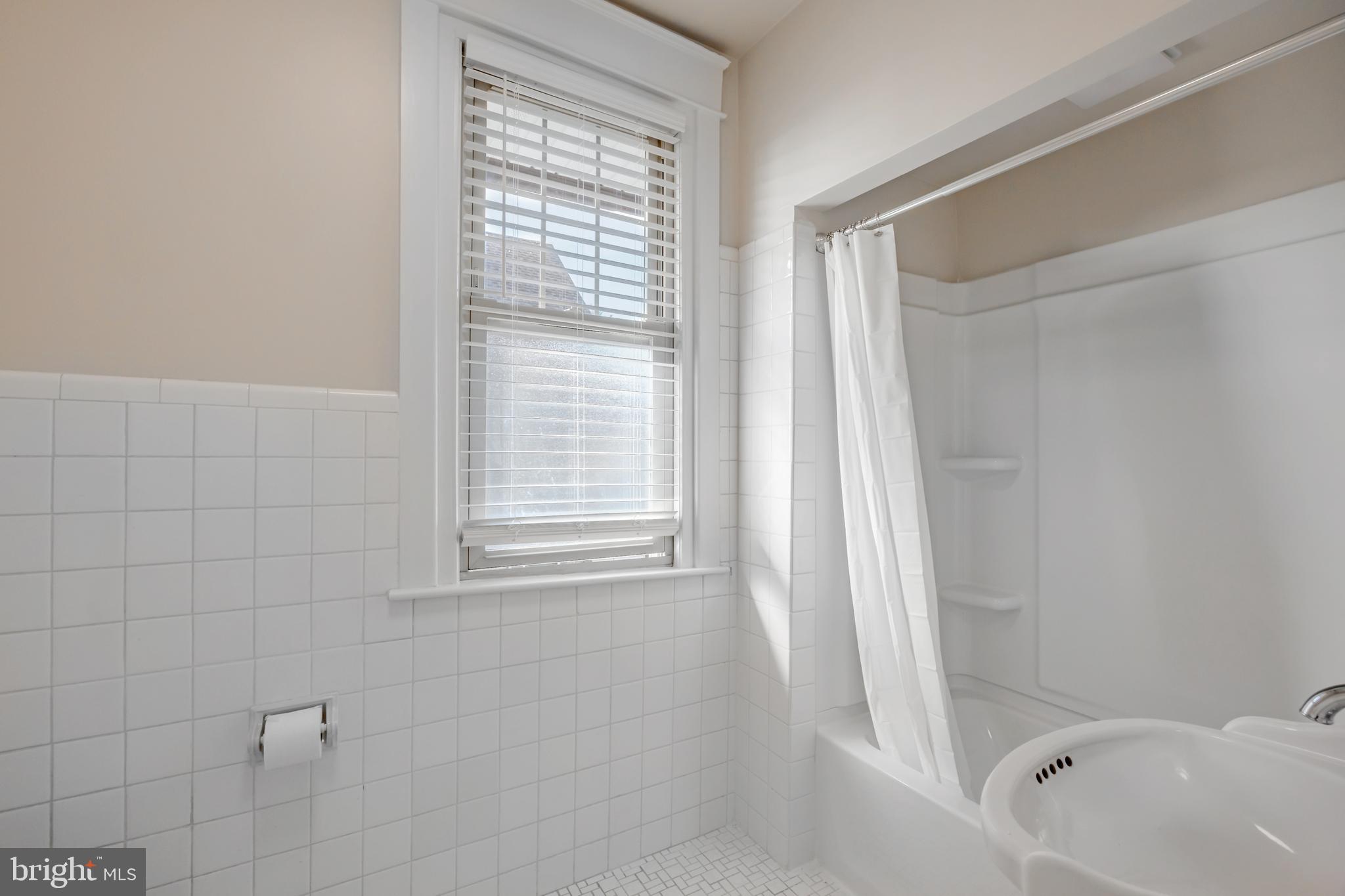 1210 West Darby Road Havertown, PA 19083 - Photo 15 of 33 a bathroom with a bathtub a shower and a window