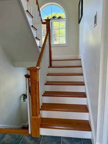 a view of entryway with wooden floor and a front door