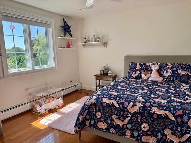 a bed sitting in a bedroom next to a window