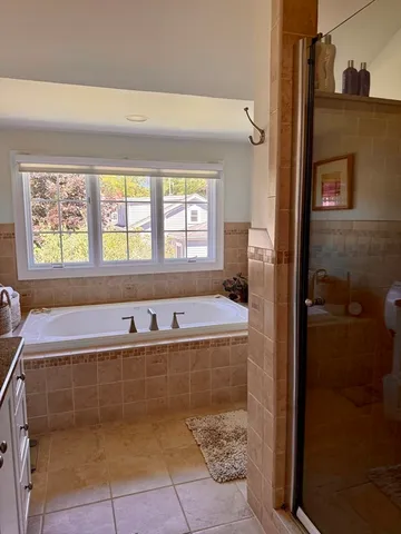 a bath tub sitting in a bathroom next to a window