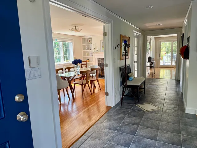 a view of a entryway door and dining room