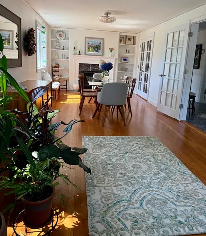 a living room with fireplace furniture and a wooden floor