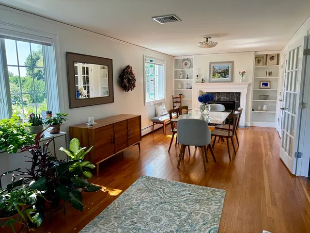 a living room with furniture potted plant and a window