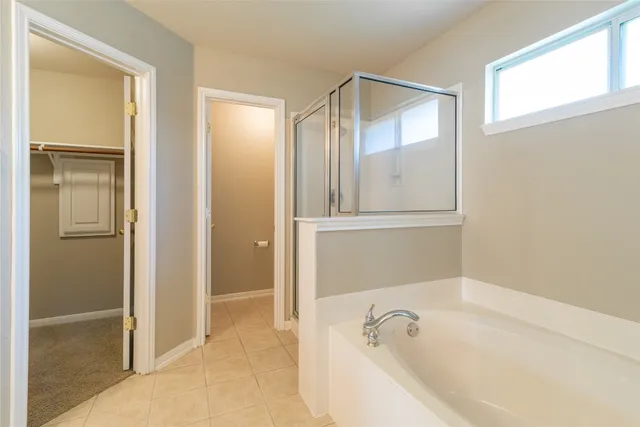 a bathroom with a bathtub and a shower