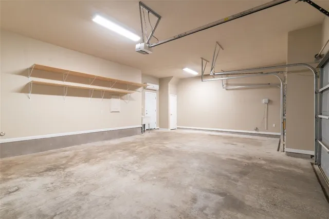 an empty room with a ceiling fan and windows