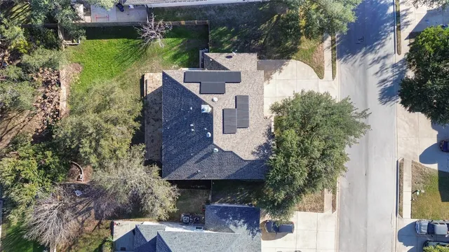 an aerial view of a house with garden space and street view