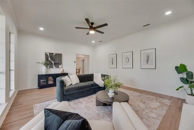 a living room with furniture and a wooden floor