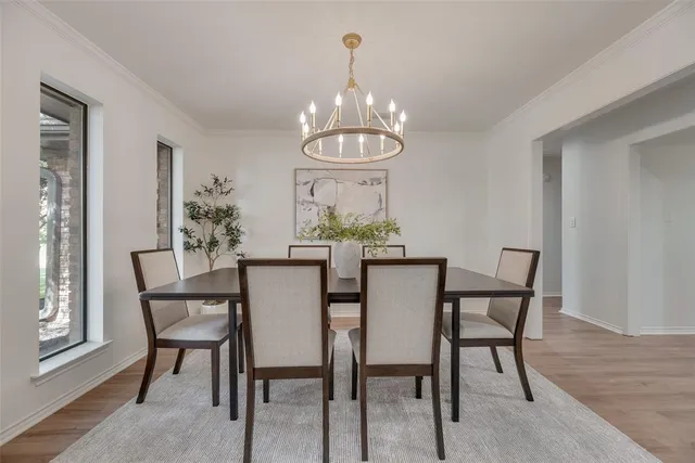 a living room with furniture a chandelier and a rug