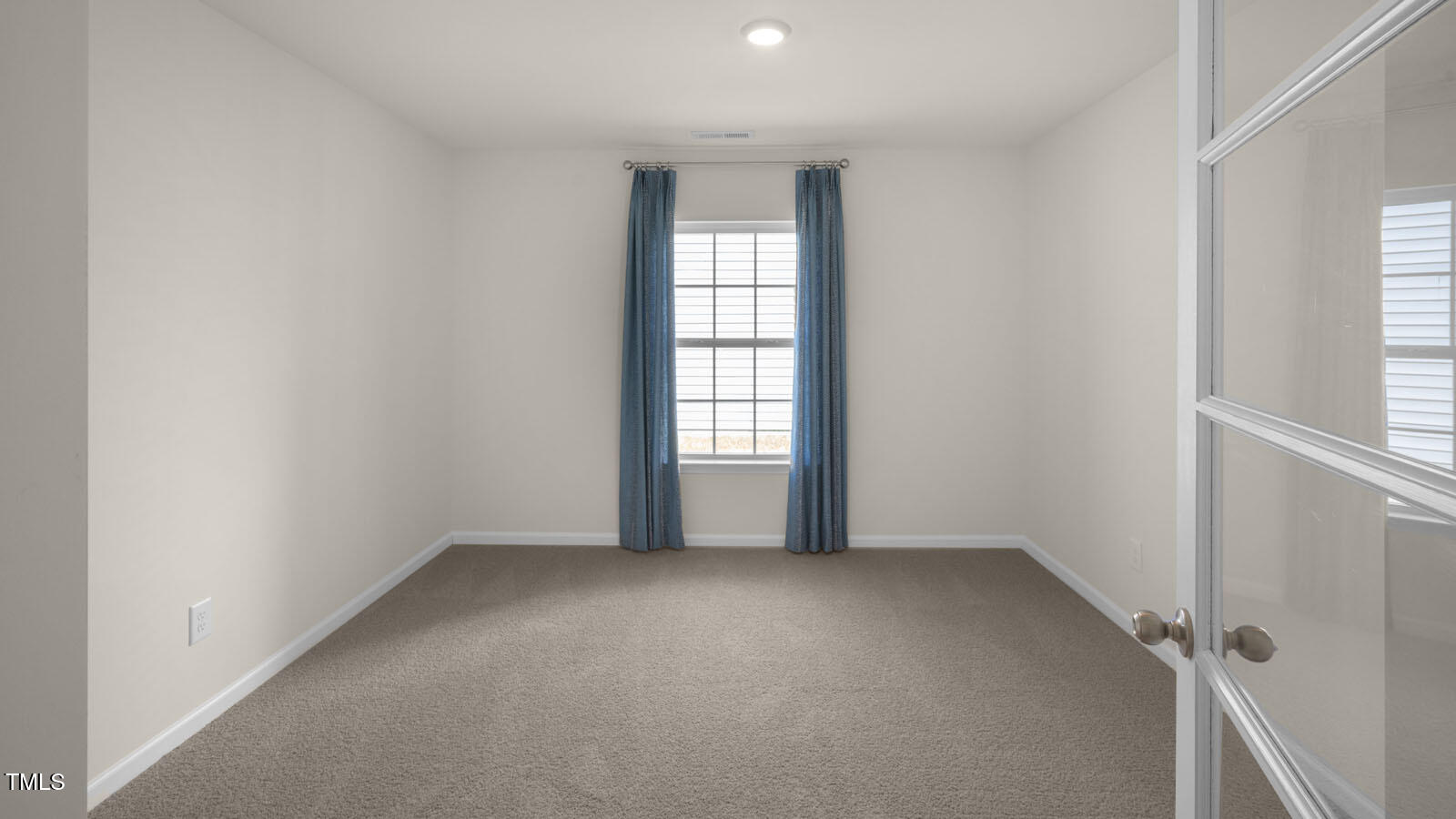 6017 Sodium Street Raleigh, NC 27610 - Photo 3 of 26 an empty room with windows