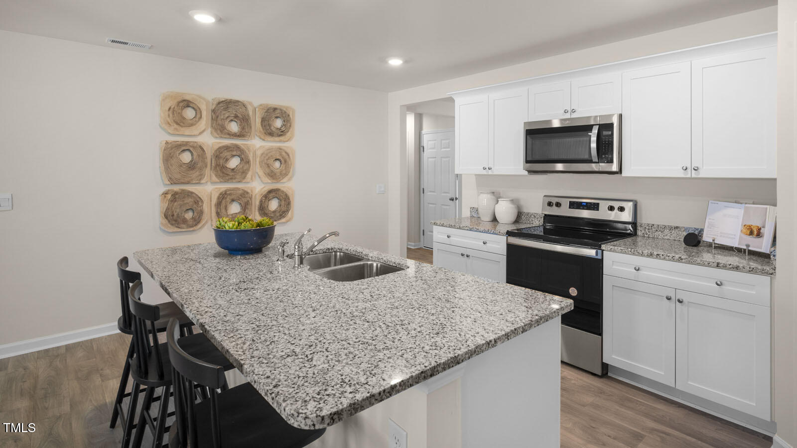 6017 Sodium Street Raleigh, NC 27610 - Photo 7 of 26 a kitchen with stainless steel appliances granite countertop a sink a stove and cabinets