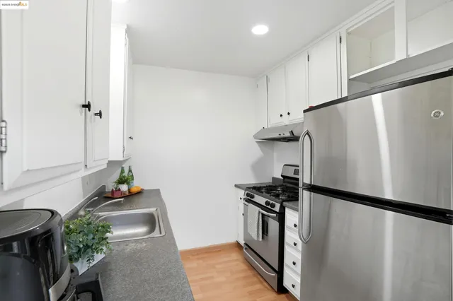 a bedroom with a bed and a lamp next to a window