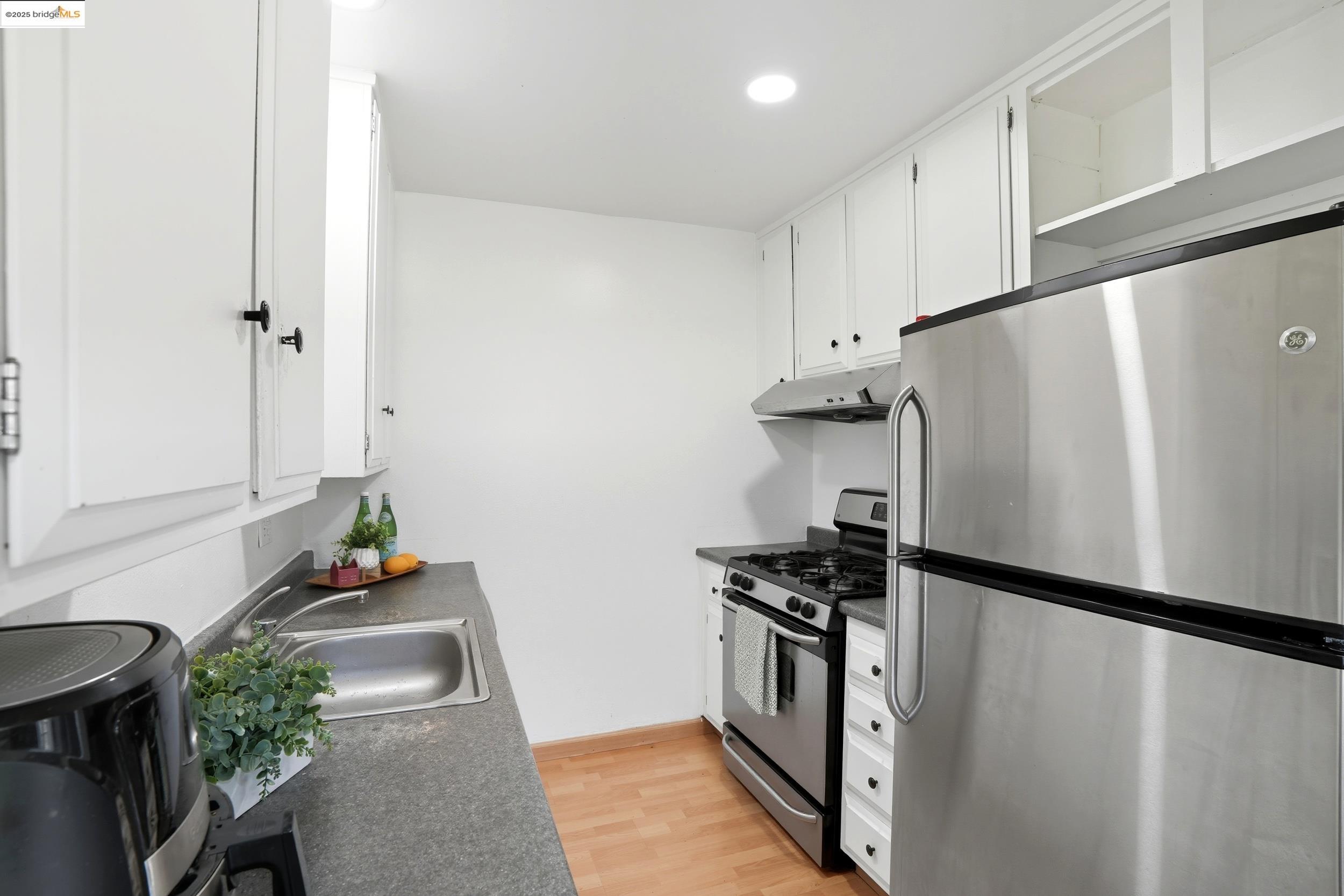 2036 Sierra Road, Unit 2 Concord, CA 94518 - Photo 12 of 32 Kitchen with appliances with stainless steel finishes, dark countertops, white cabinetry, light wood finished floors, and recessed lighting