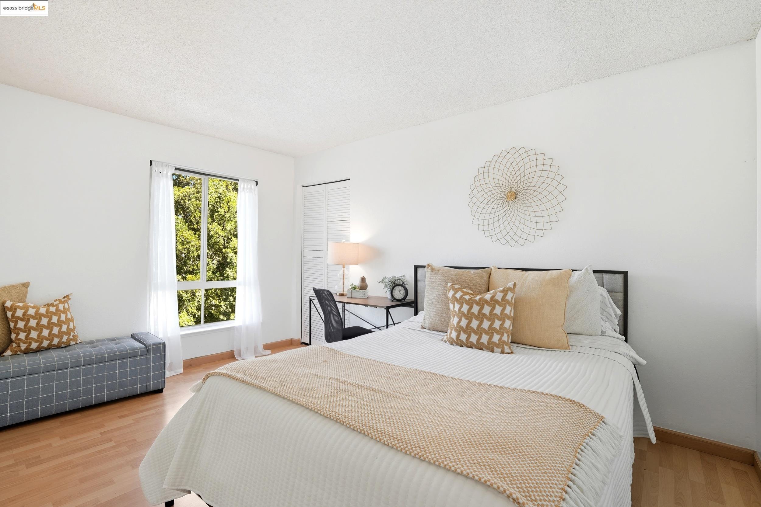 2036 Sierra Road, Unit 2 Concord, CA 94518 - Photo 22 of 32 a bedroom with a bed and wooden floor