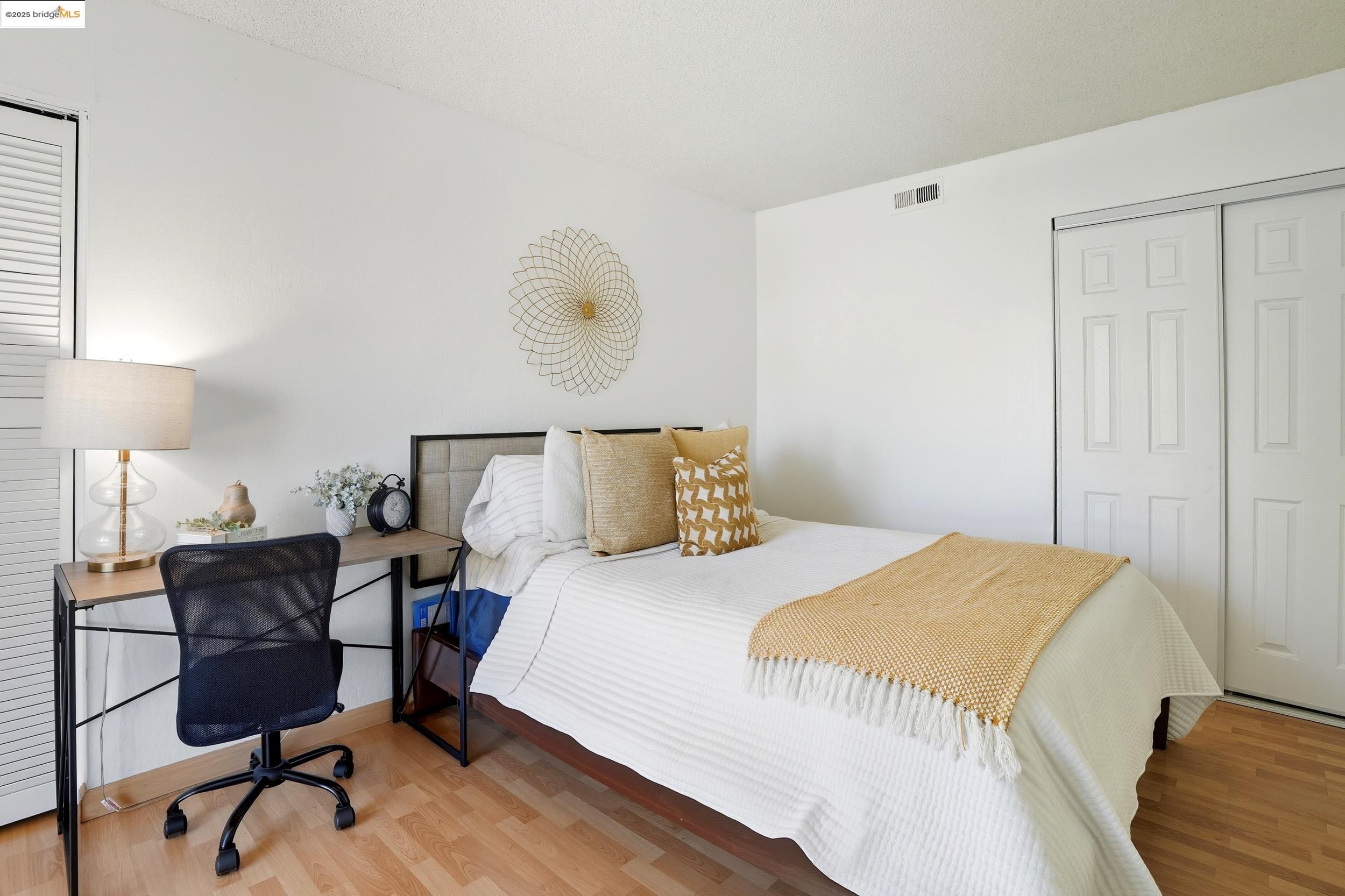 2036 Sierra Road, Unit 2 Concord, CA 94518 - Photo 24 of 32 a bedroom with a bed and a lamp next to a window