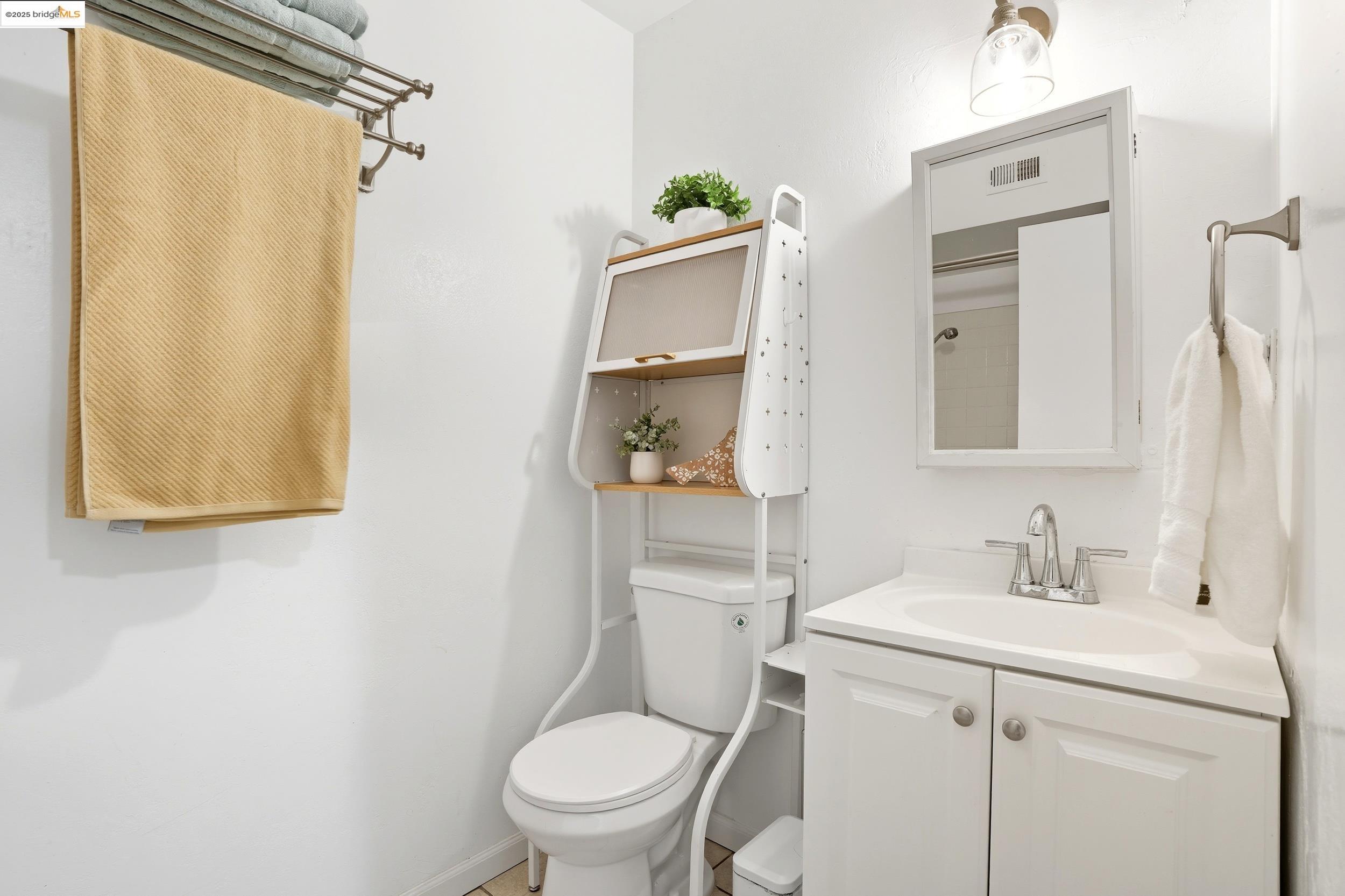 2036 Sierra Road, Unit 2 Concord, CA 94518 - Photo 26 of 32 a bathroom with a toilet sink vanity and mirror