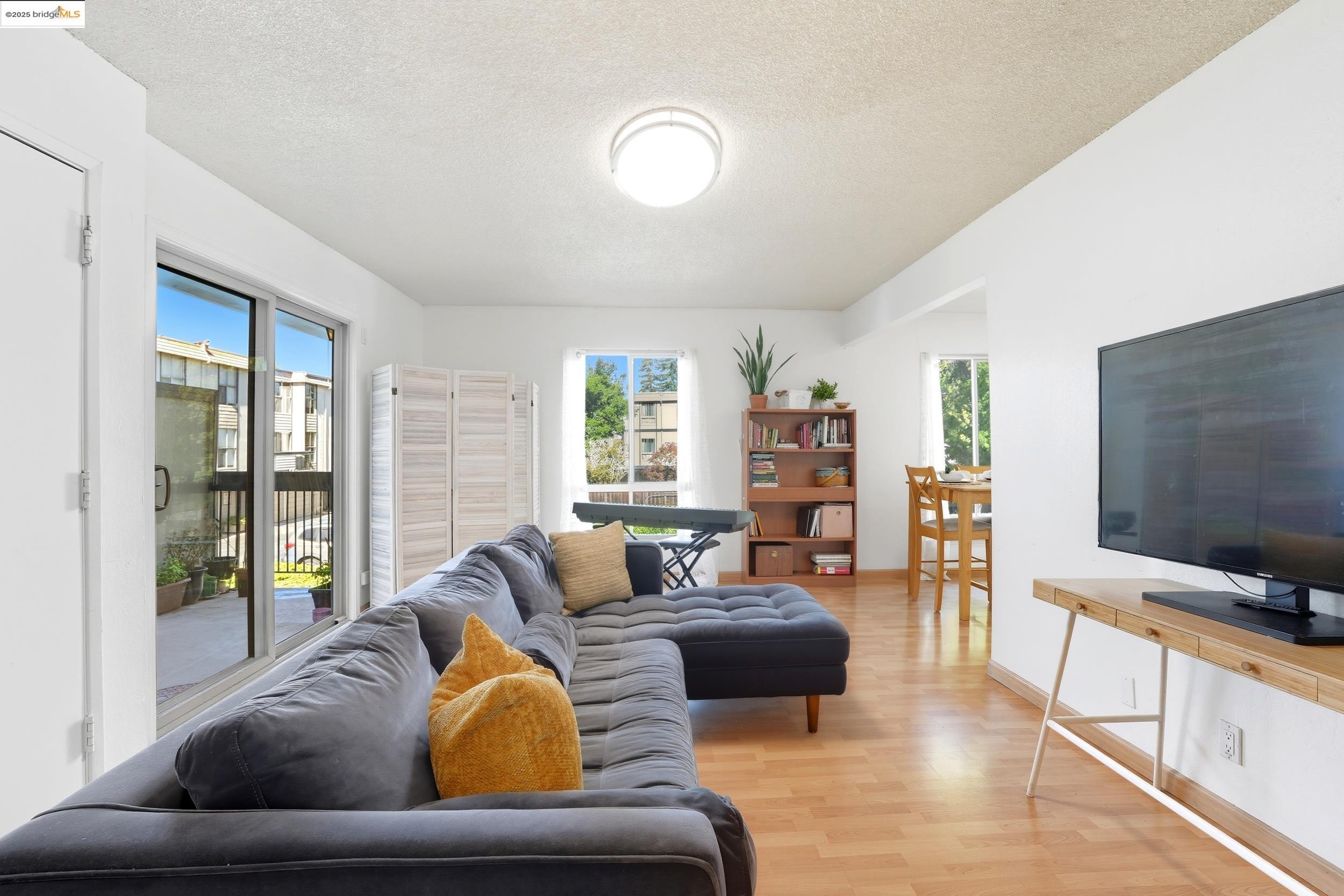 2036 Sierra Road, Unit 2 Concord, CA 94518 - Photo 4 of 32 Living area featuring healthy amount of natural light, light wood finished floors, and a textured ceiling