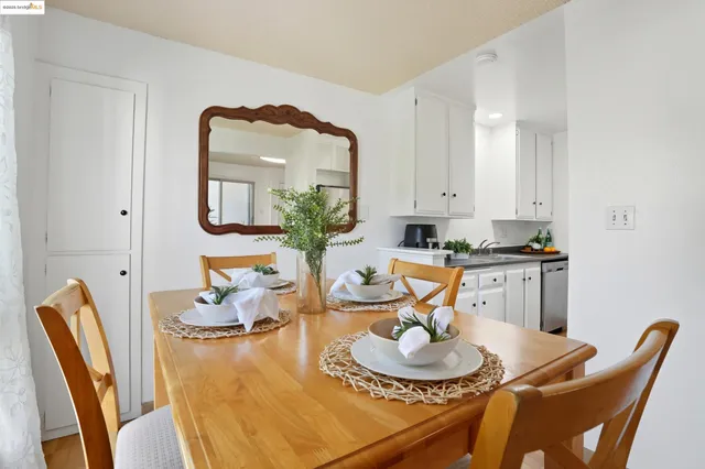 a view of a dining room with furniture and a potted plant