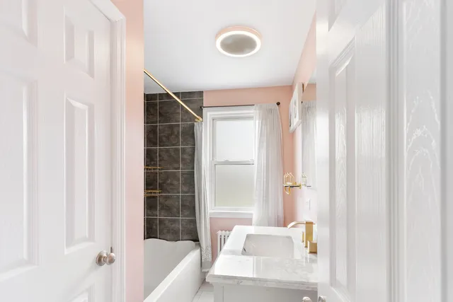 a bathroom with a bathtub and a shower