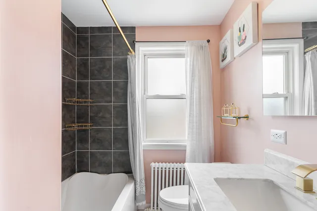 a bathroom with a bathtub and a shower