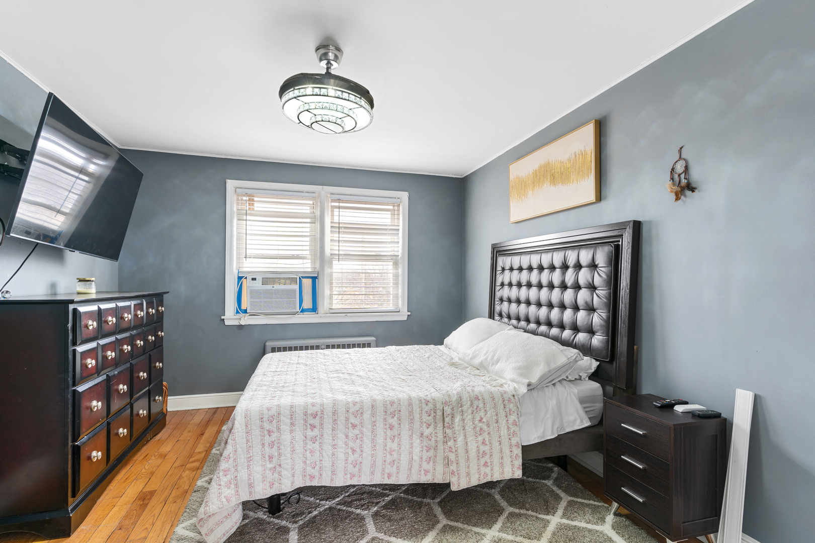 2204 South 9th Avenue, Unit 2 Broadview, IL 60155 - Photo 14 of 16 a bedroom with a bed and a flat screen tv