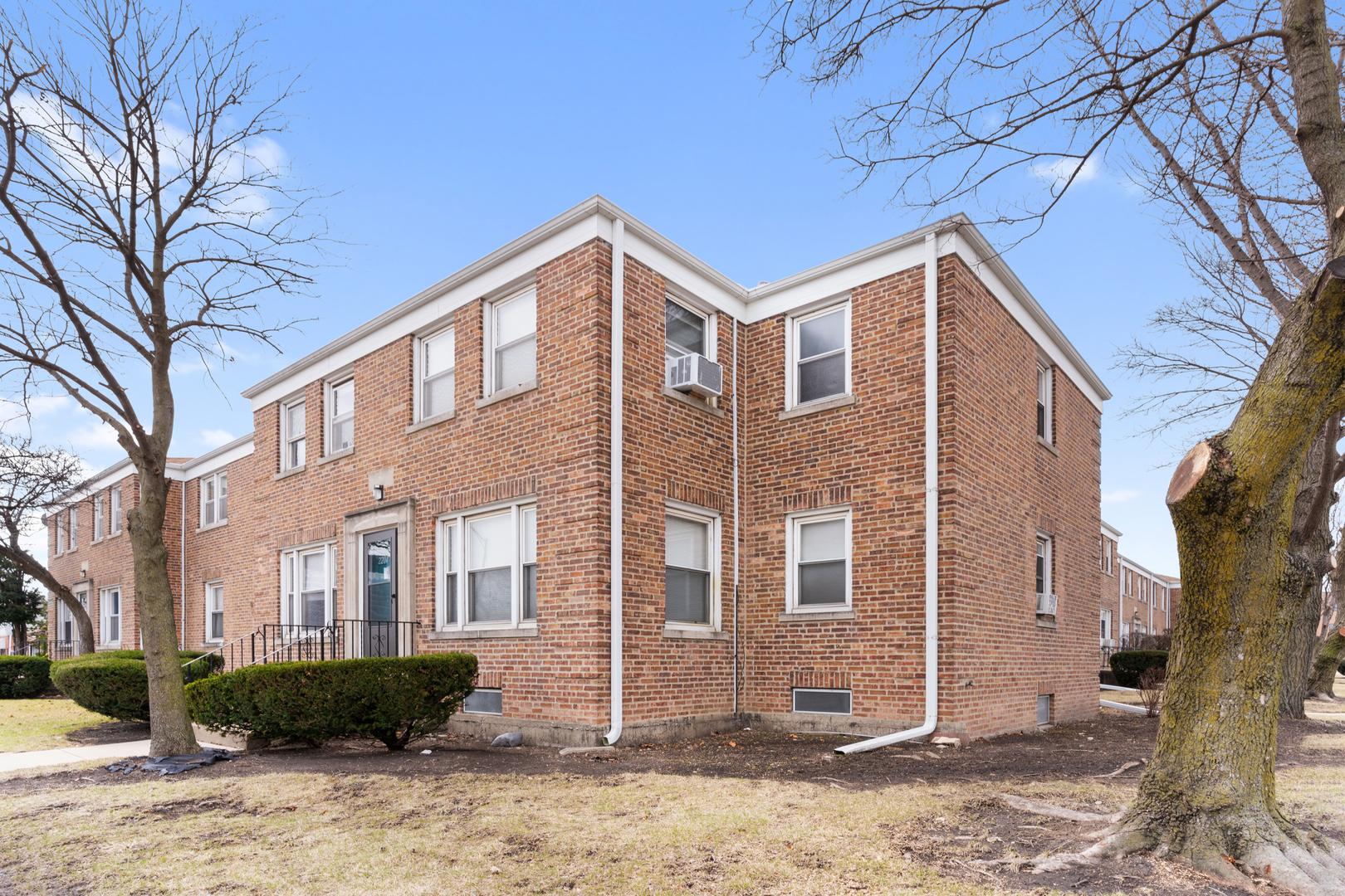 2204 South 9th Avenue, Unit 2 Broadview, IL 60155 - Photo 15 of 16 a front view of a house with yard and trees around