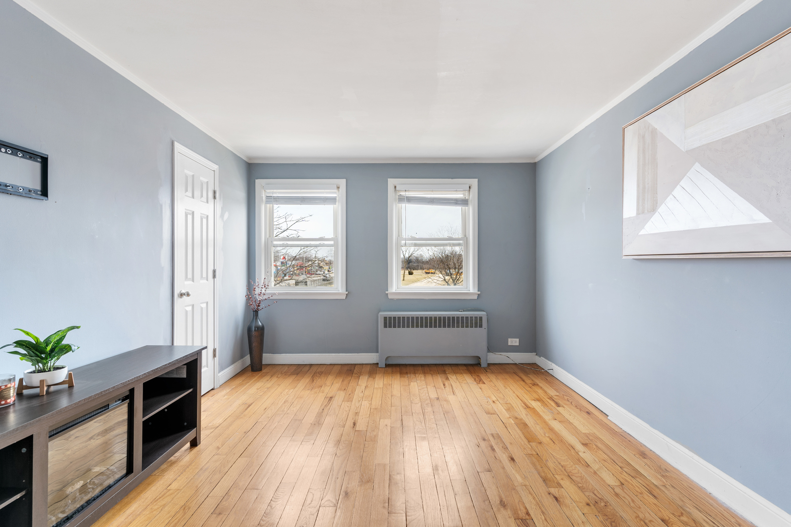 2204 South 9th Avenue, Unit 2 Broadview, IL 60155 - Photo 2 of 16 an empty room with wooden floor and windows