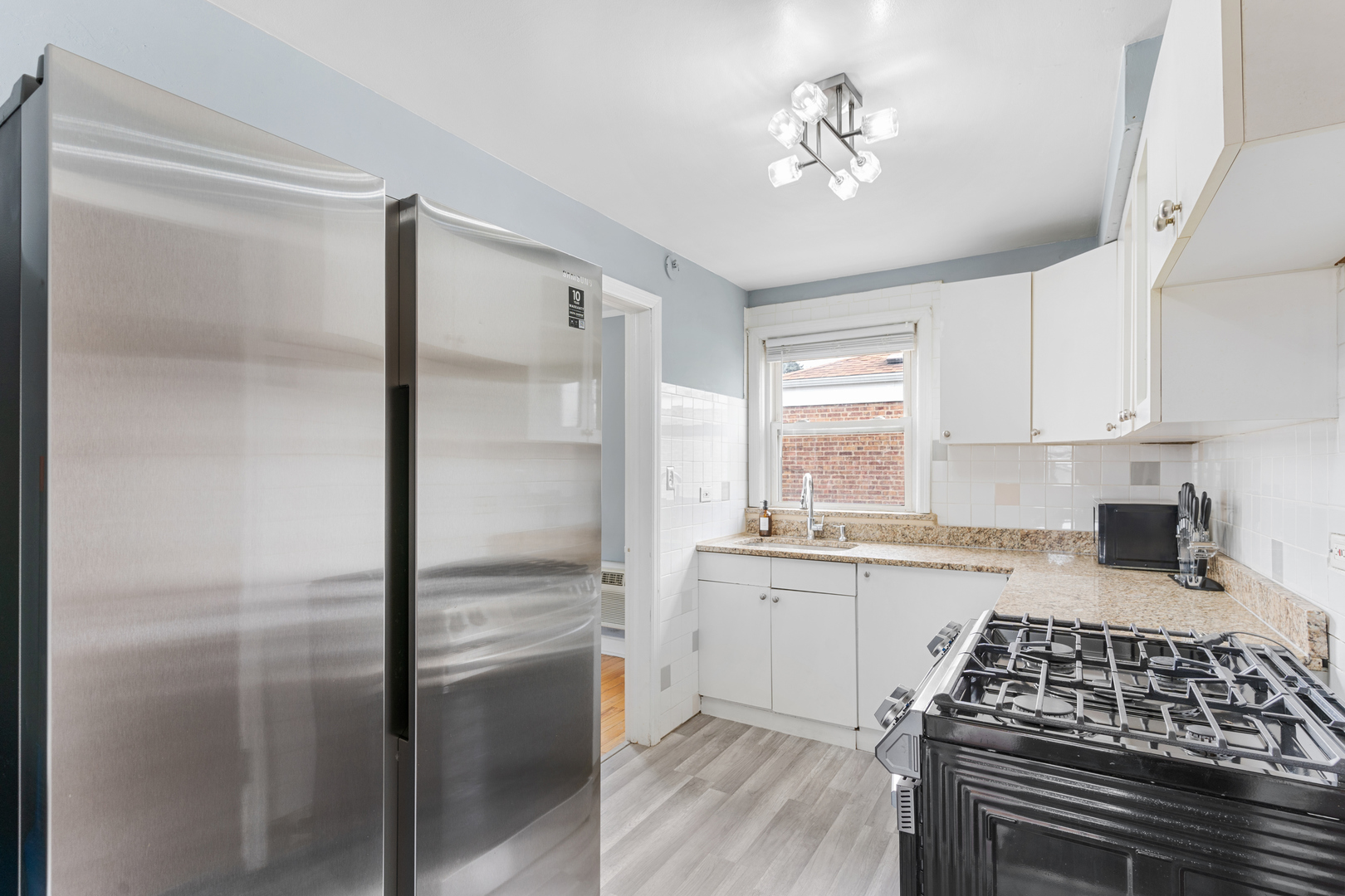 2204 South 9th Avenue, Unit 2 Broadview, IL 60155 - Photo 5 of 16 a kitchen with a refrigerator and a stove top oven
