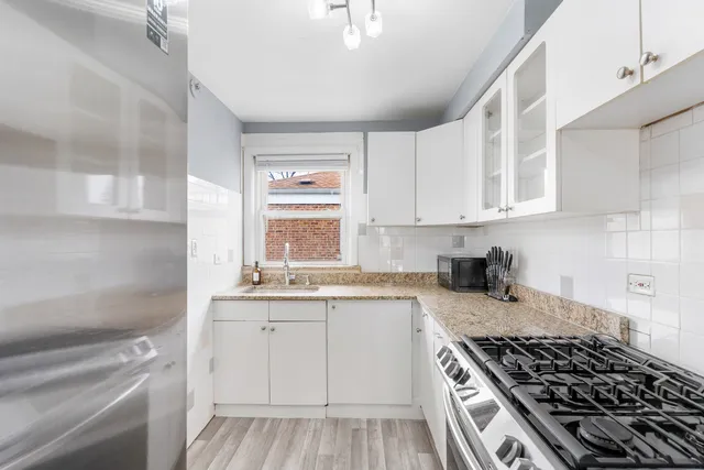 a kitchen with sink stove and cabinets