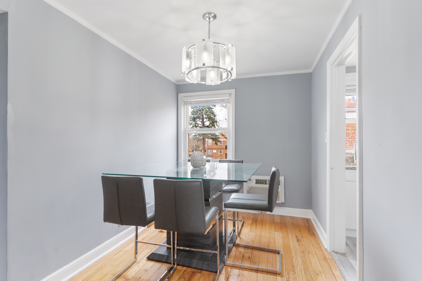 2204 South 9th Avenue, Unit 2 Broadview, IL 60155 - Photo 8 of 16 a view of a dining room with furniture wooden floor and chandelier