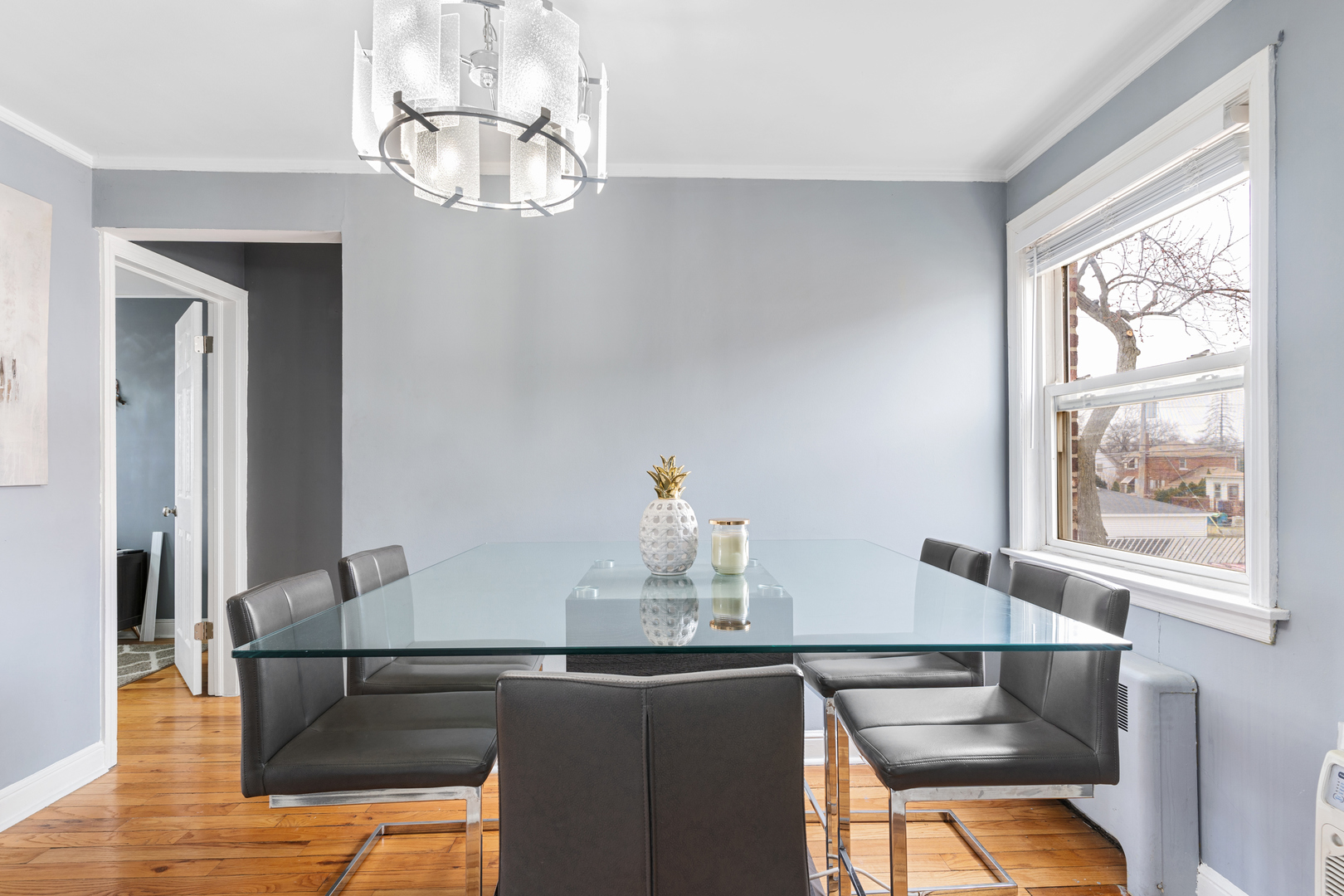 2204 South 9th Avenue, Unit 2 Broadview, IL 60155 - Photo 9 of 16 a kitchen with stainless steel appliances kitchen island granite countertop a table and a chandelier