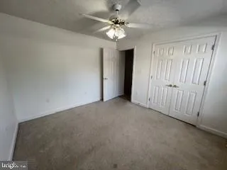 a view of a livingroom with a chandelier fan