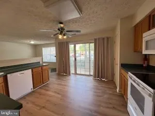 a large kitchen with stainless steel appliances granite countertop a stove a sink and a refrigerator