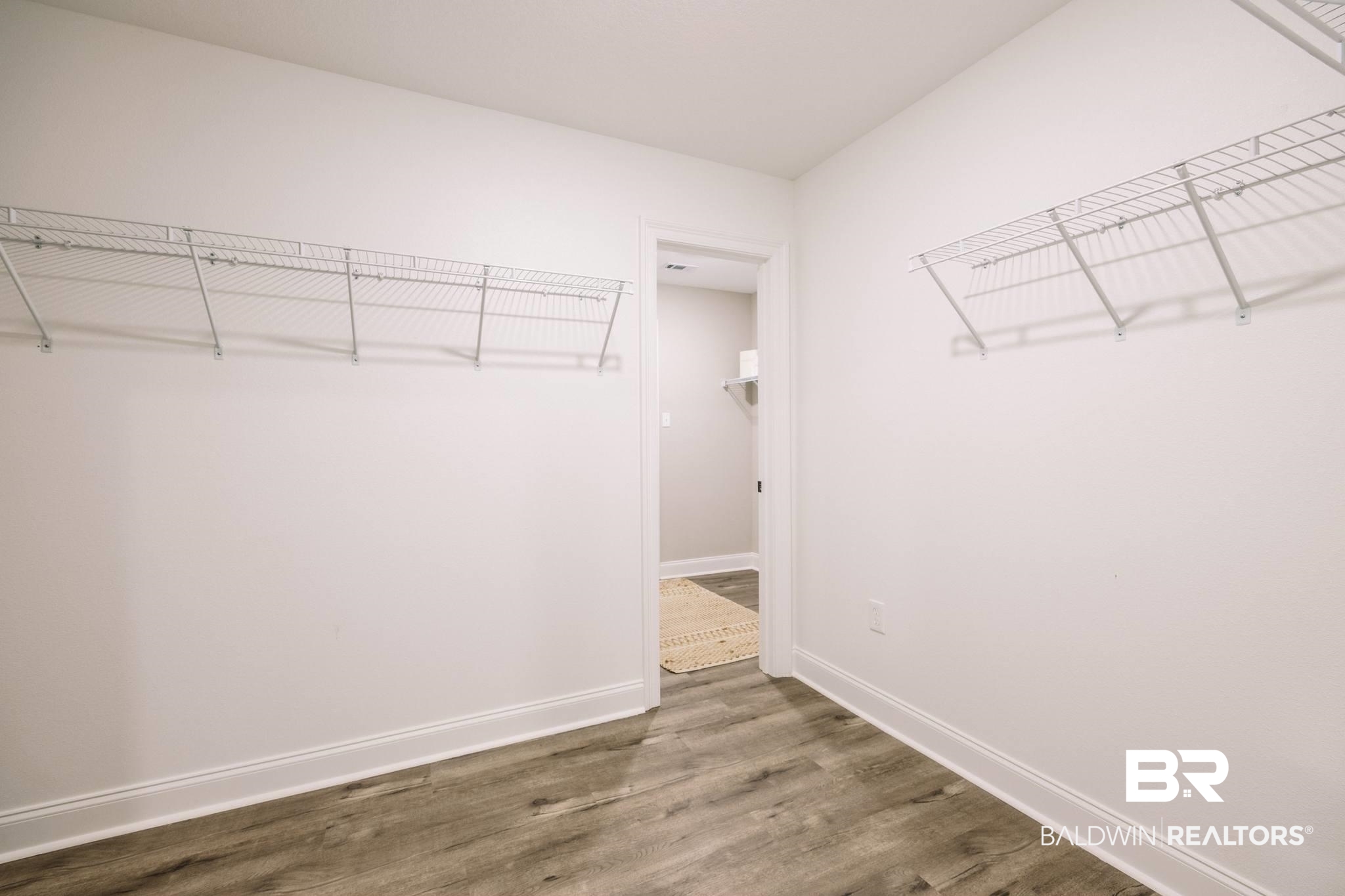 12918 Flanagan Street Elberta, AL 36530 - Photo 5 of 33 Spacious closet featuring durable wire shelving, light wood-finish flooring, and white baseboards