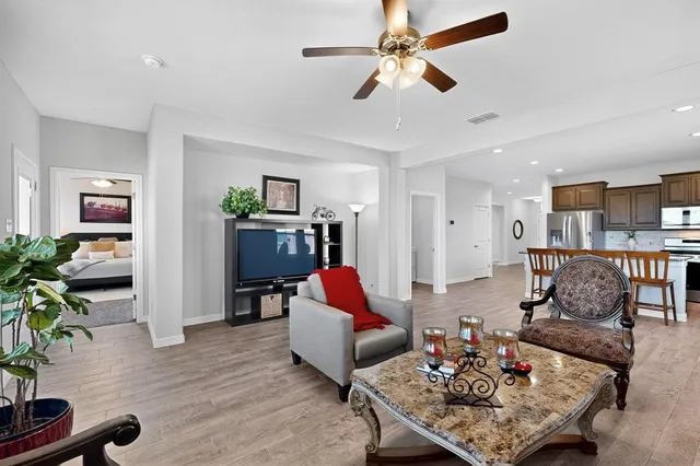 a living room with furniture and wooden floor