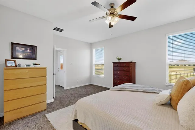 a bedroom with a bed and a dresser