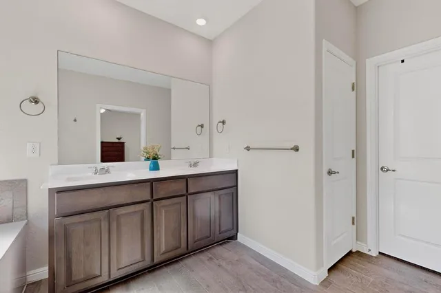 a bathroom with a double vanity sink and mirror