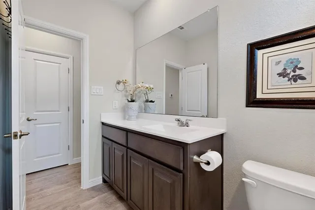 a bathroom with a toilet a sink and mirror