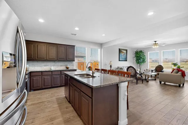 a kitchen with counter top space a sink appliances and cabinets