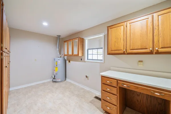 a kitchen with stainless steel appliances granite countertop a sink and cabinets with wooden floor