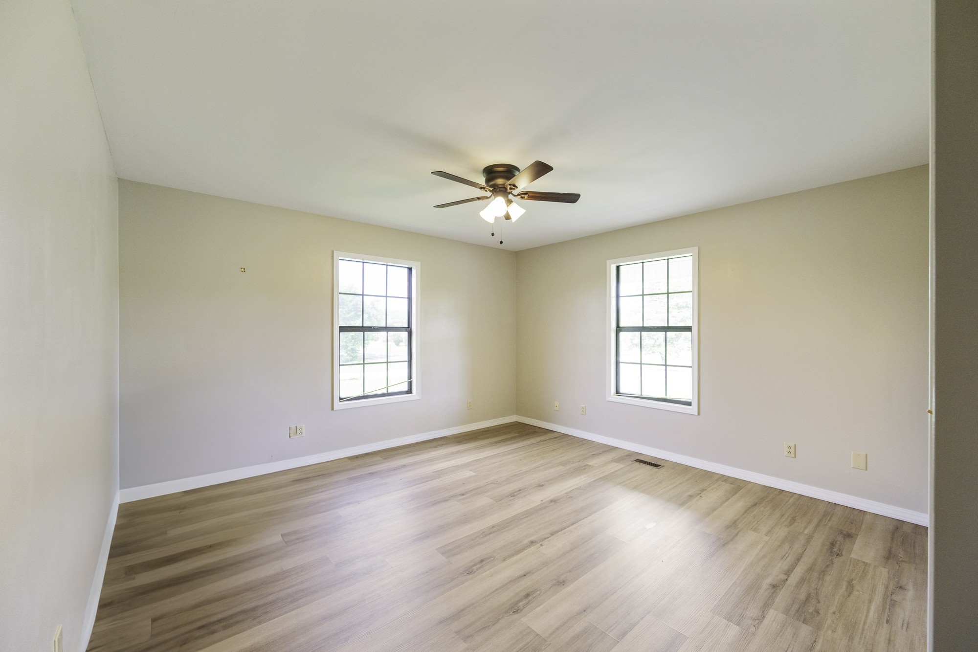 17930 West Main Street Huntingdon, TN 38344 - Photo 17 of 28 an empty room with wooden floor and windows