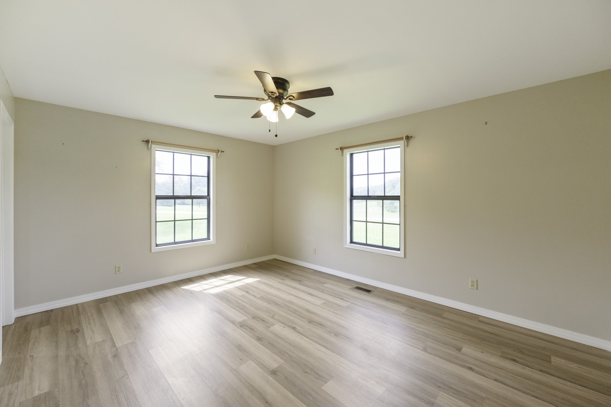 17930 West Main Street Huntingdon, TN 38344 - Photo 19 of 28 a view of an empty room with a window and wooden floor