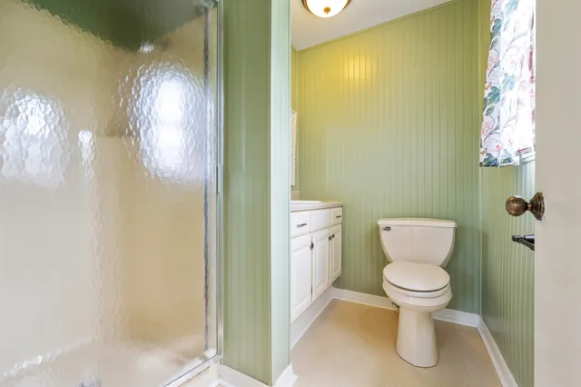 a white toilet sitting next to a bathroom sink