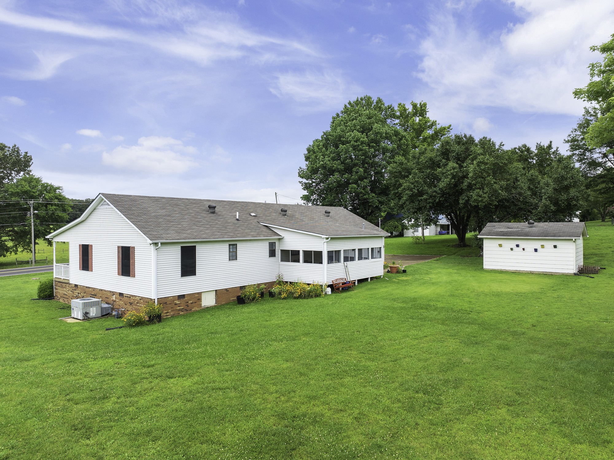 17930 West Main Street Huntingdon, TN 38344 - Photo 2 of 28 a front view of a house with a yard and trees