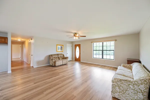a view of a livingroom with furniture and wooden floor
