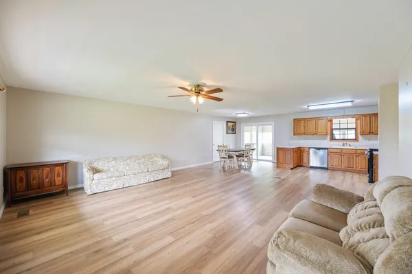 a living room with furniture and wooden floor