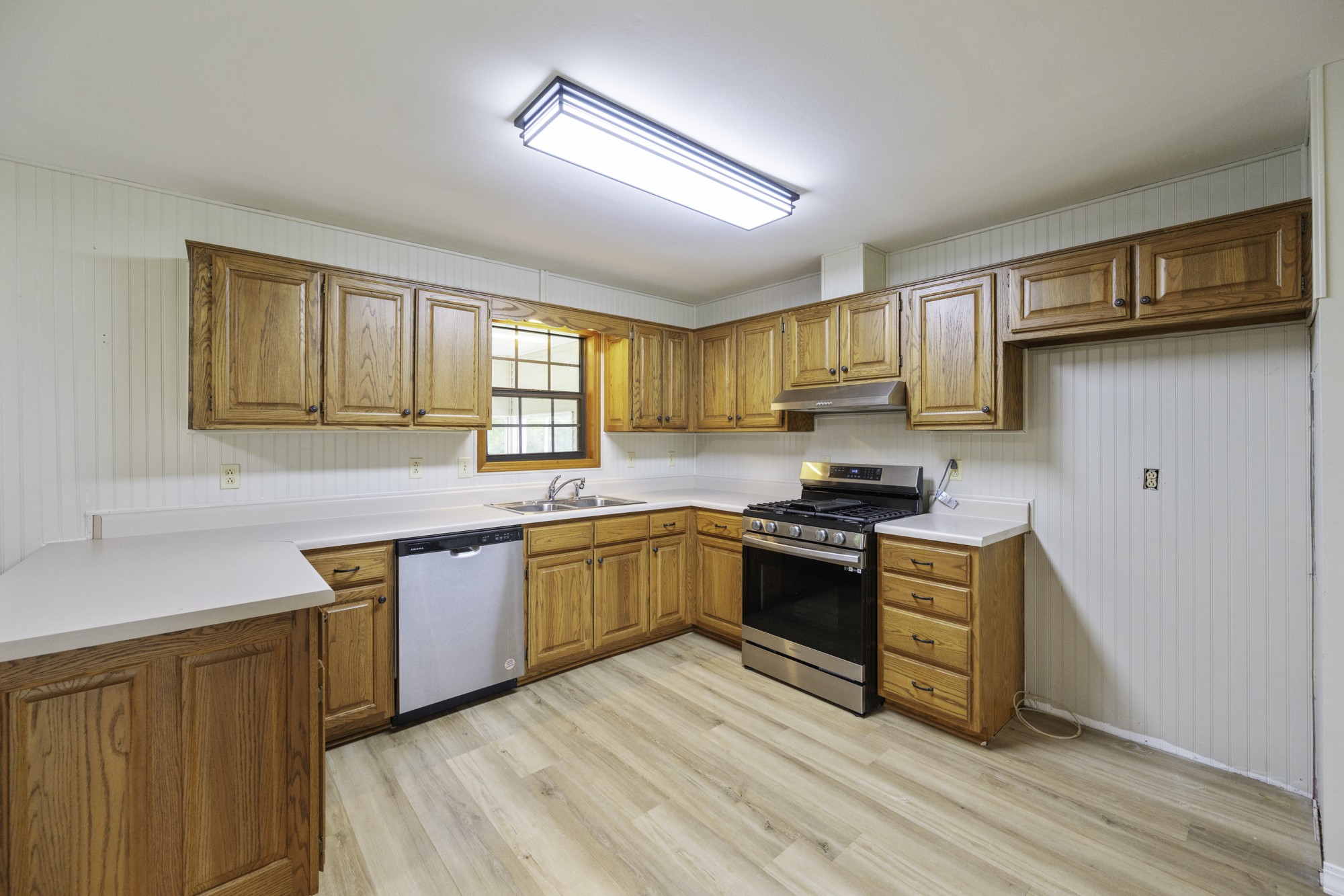 17930 West Main Street Huntingdon, TN 38344 - Photo 10 of 28 a kitchen with stainless steel appliances granite countertop a stove a sink dishwasher and a refrigerator