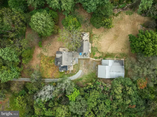 an aerial view of a house with yard and lake view