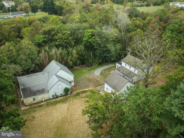 an aerial view of a house with a yard and lake view